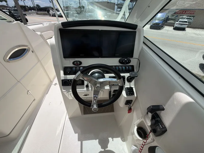 Slide: The Image of Interior view of the helm in a 2022 Sailfish 245 DC boat. - 14