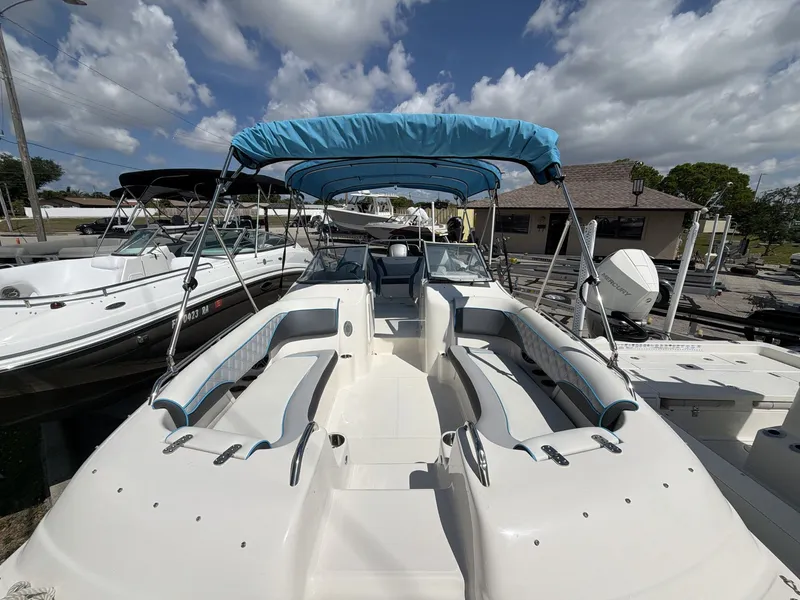 Slide: The Image of 2023 Splender 259 Sunstar boat with blue sunshade at the dock. - 10
