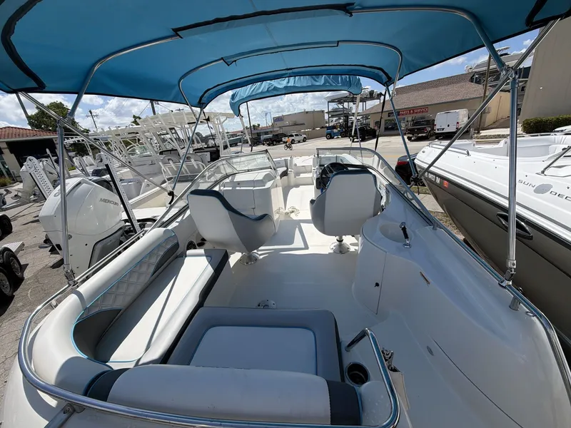 Slide: The Image of Interior view of 2023 Splender 259 Sunstar boat with blue canopy. - 11