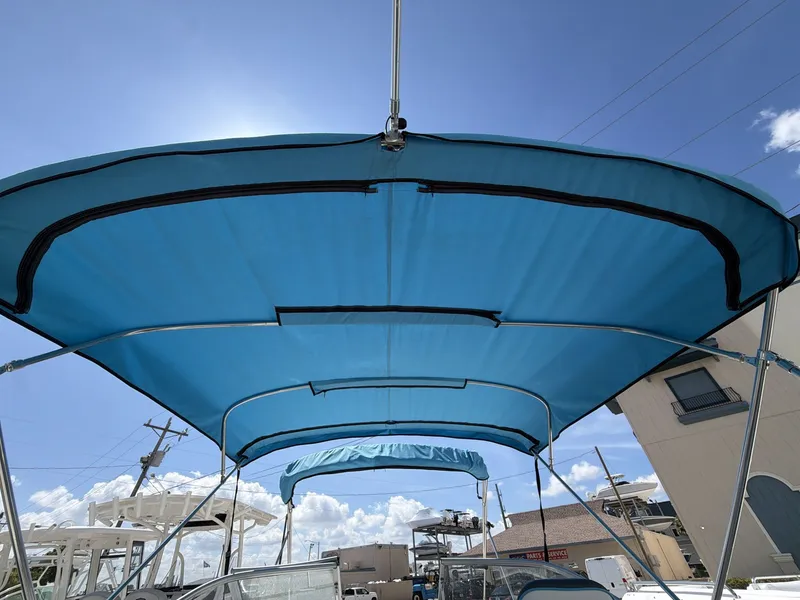 Slide: The Image of Splender 259 Sunstar 2023 with blue sunshade outdoors. - 3