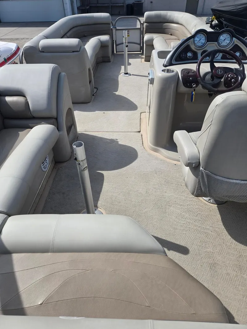 Slide: The Image of Interior of a 2007 Starcraft Majestic 256 pontoon boat with gray seating. - 14