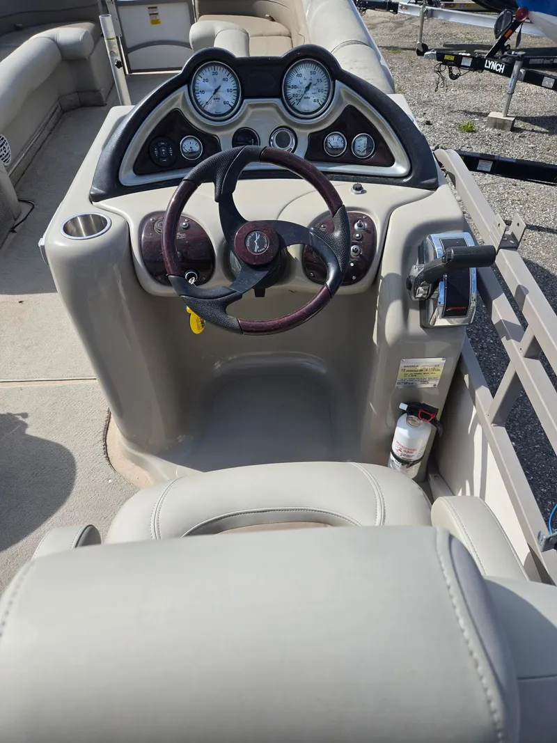 Slide: The Image of 2007 Starcraft Majestic 256 boat console with steering wheel and gauges. - 16