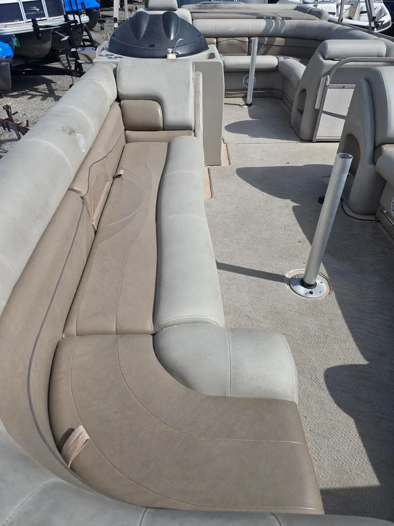 Slide: The Image of Interior of a 2007 Starcraft Majestic 256 pontoon boat with beige seating. - 9
