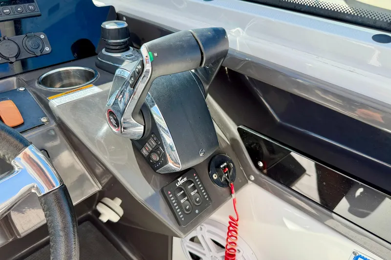 Slide: The Image of Control panel of 2023 Blackfin 272 DC boat, featuring throttle and steering wheel. - 14