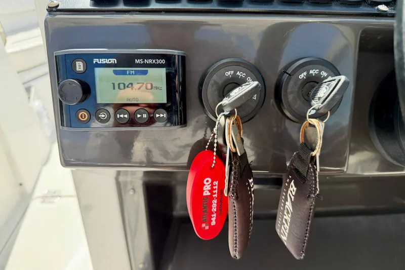 Slide: The Image of 2023 Blackfin 272 DC dashboard with Fusion MS-NRX300 radio and ignition keys. - 15