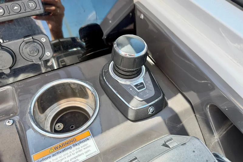 Slide: The Image of Control panel of 2023 Blackfin 272 DC boat with joystick and cup holder. - 17