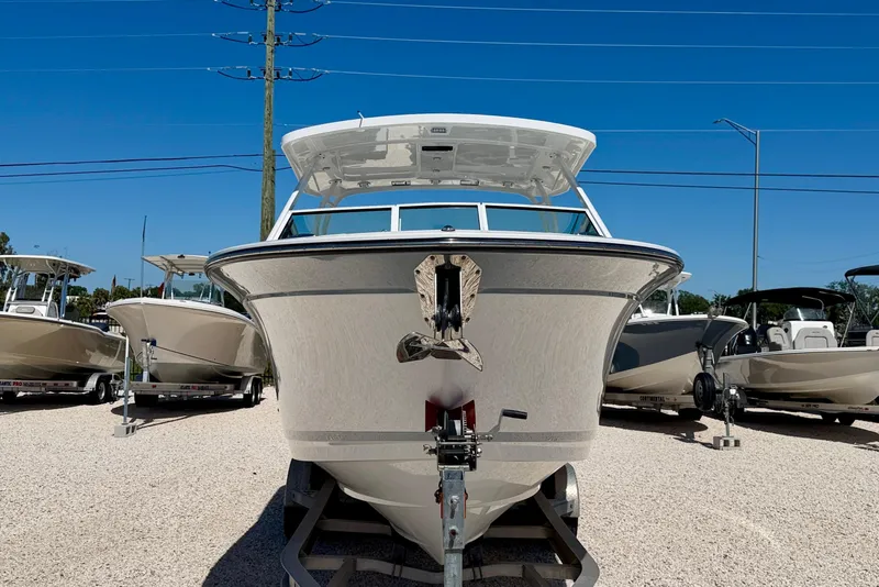 Slide: The Image of 2023 Blackfin 272 DC boat on display in a sunny outdoor showroom. - 2