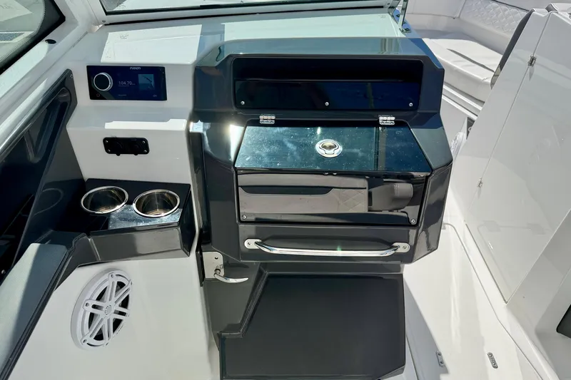 Slide: The Image of 2023 Blackfin 272 DC boat interior with control panel and cup holders. - 20