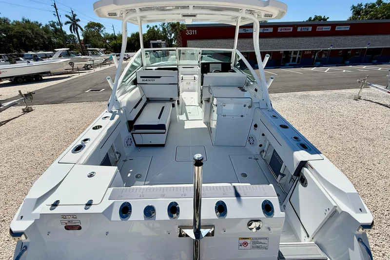 Slide: The Image of 2023 Blackfin 272 DC boat interior with seating and storage, displayed outdoors. - 24