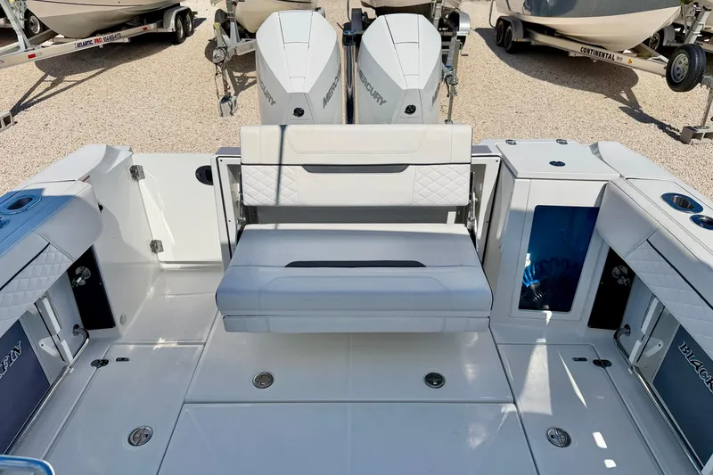 Slide: The Image of 2023 Blackfin 272 DC boat interior with seating and dual Mercury engines. - 26