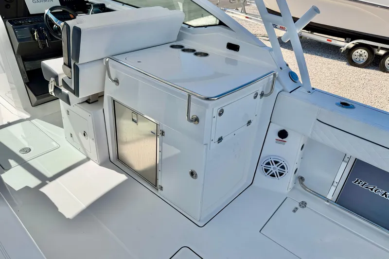 Slide: The Image of 2023 Blackfin 272 DC boat interior with helm, seating, and storage compartments. - 27