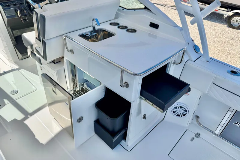 Slide: The Image of 2023 Blackfin 272 DC boat interior with sink, storage, and seating area. - 28