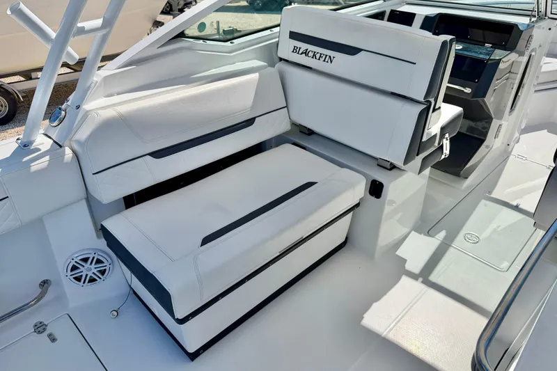 Slide: The Image of 2023 Blackfin 272 DC boat interior with white seating and modern dashboard. - 30