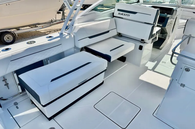 Slide: The Image of 2023 Blackfin 272 DC boat interior with white seating and modern design. - 31