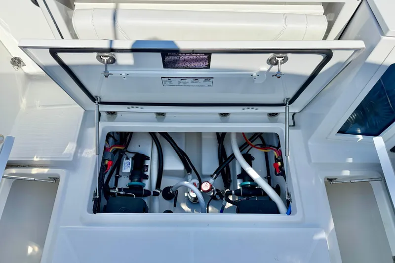Slide: The Image of Open hatch of 2023 Blackfin 272 DC boat showing internal components and wiring. - 38