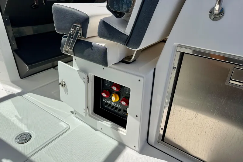 Slide: The Image of 2023 Blackfin 272 DC boat interior with open storage compartment and seating. - 39
