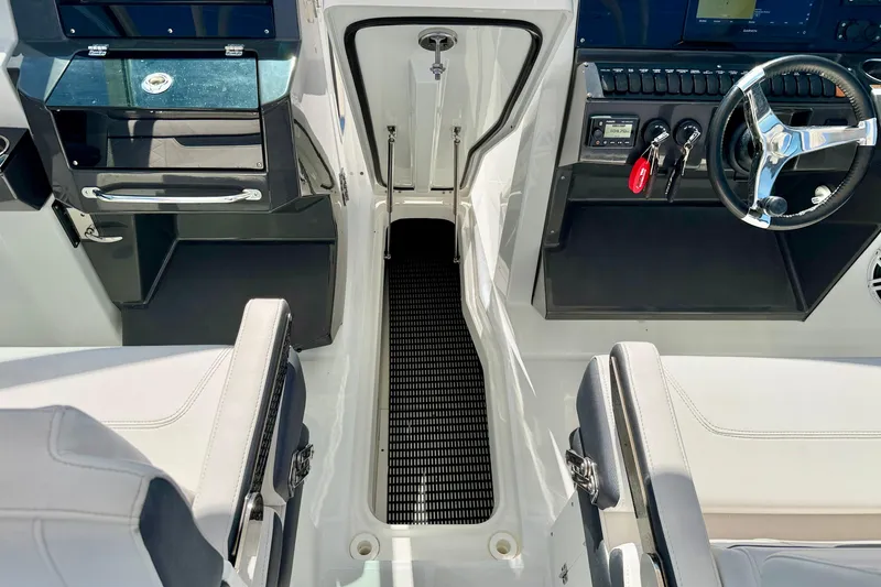 Slide: The Image of 2023 Blackfin 272 DC boat interior with steering wheel and seating area. - 40