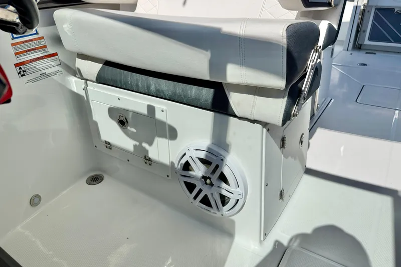 Slide: The Image of 2023 Blackfin 272 DC boat interior with cushioned seat and speaker. - 45
