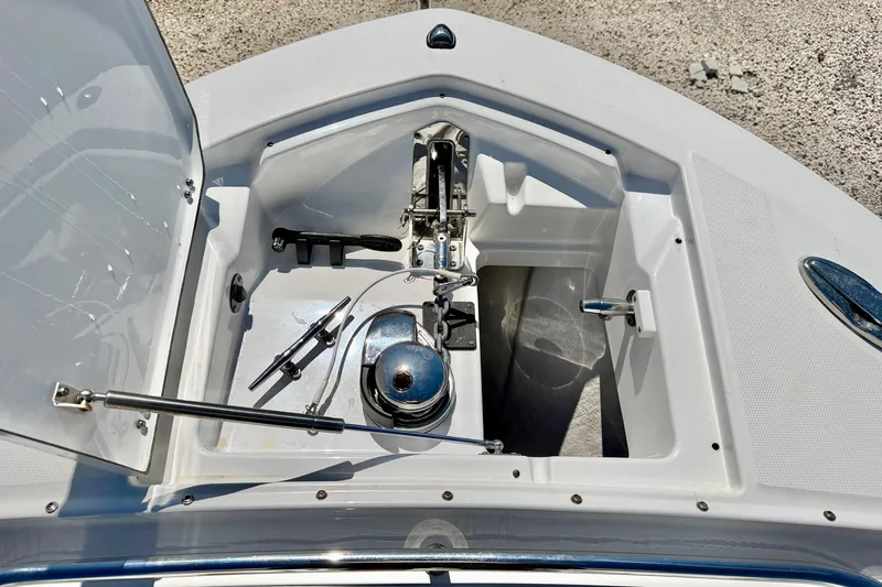 Slide: The Image of 2023 Blackfin 272 DC boat anchor compartment with open hatch and visible winch system. - 48
