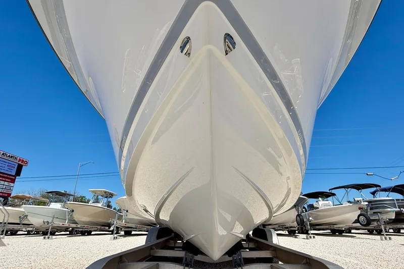 Slide: The Image of 2023 Blackfin 272 DC boat on trailer, viewed from below, with clear blue sky. - 49