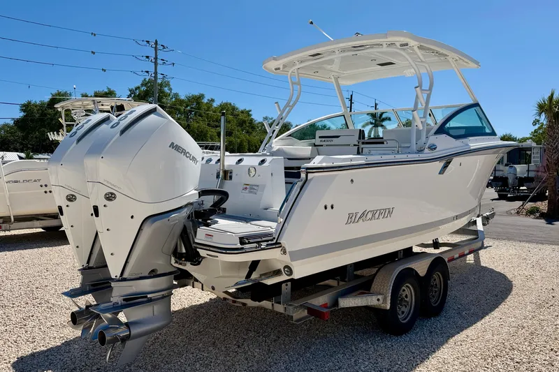 Slide: The Image of 2023 Blackfin 272 DC boat with dual Mercury engines on a trailer. - 5