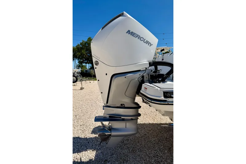 Slide: The Image of 2023 Blackfin 272 DC boat with Mercury outboard motor in a sunny outdoor setting. - 51