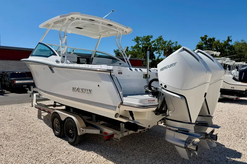 Slide: The Image of 2023 Blackfin 272 DC boat with dual Mercury engines on a trailer. - 7