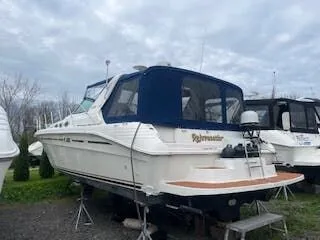 The Image of 1999 Sea Ray Sundancer boat on stands outdoors. - 1