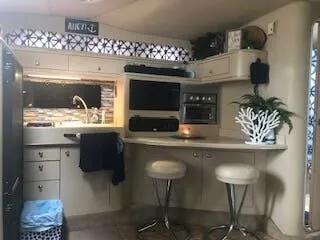 Slide: The Image of Interior of a 1999 Sea Ray Sundancer yacht kitchen with modern amenities. - 11