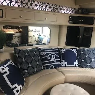 Slide: The Image of Interior of a 1999 Sea Ray Sundancer with blue cushions. - 13