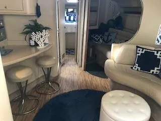 Slide: The Image of Interior of a 1999 Sea Ray Sundancer yacht with elegant furnishings. - 15