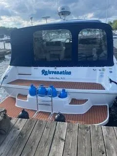 Slide: The Image of 1999 Sea Ray Sundancer boat docked with blue cover. - 3