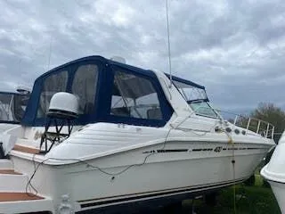 Slide: The Image of 1999 Sea Ray Sundancer boat with blue cover outdoors. - 5