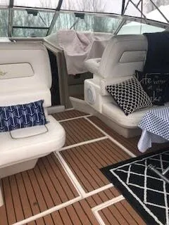 Slide: The Image of Interior of a 1999 Sea Ray Sundancer with elegant seating and wooden flooring. - 8
