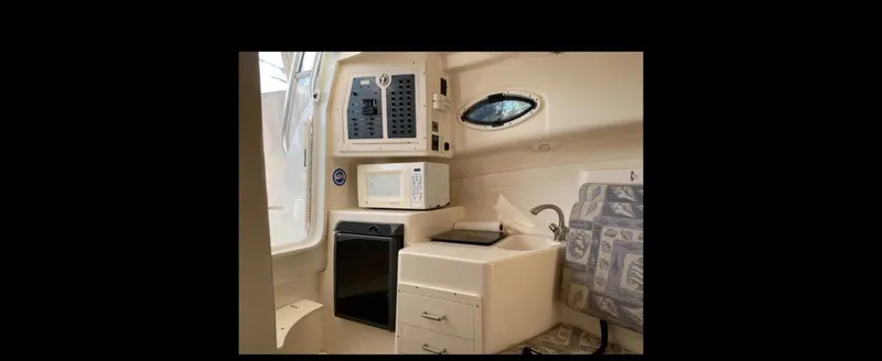 Slide: The Image of Interior of 2006 Polar Kraft Sportsman Series 27 with kitchenette and seating area. - 11