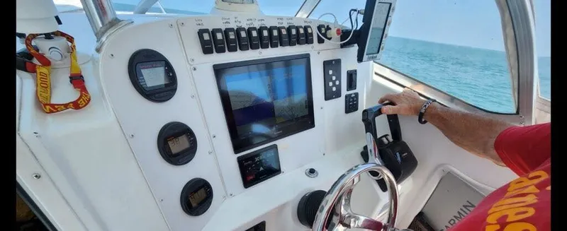 Slide: The Image of Control console of a 2006 Polar Kraft Sportsman Series 27 boat on the sea. - 5