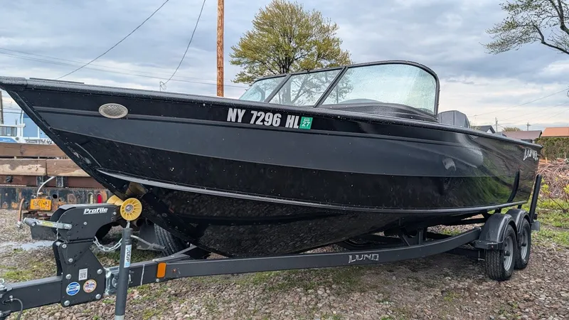Slide: The Image of 2024 Lund Fisherman 2075 on trailer, black color, side view. - 3