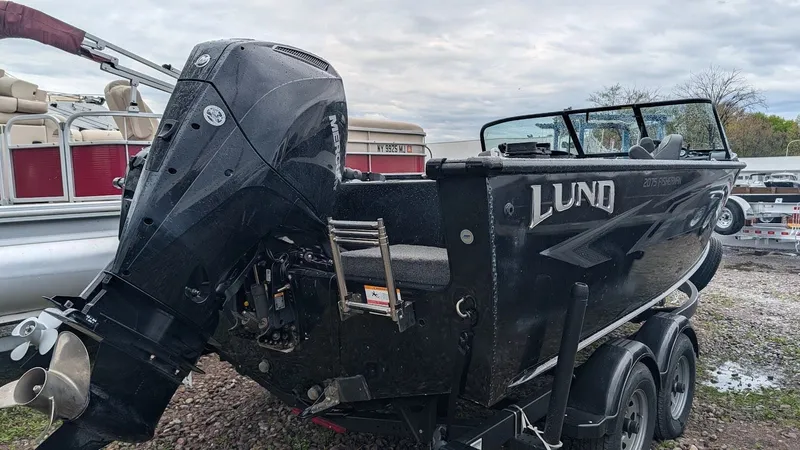 Slide: The Image of 2024 Lund Fisherman 2075 with outboard motor on trailer. - 4