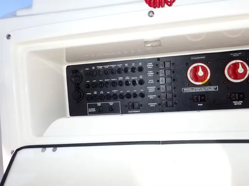 Slide: The Image of 2018 Pathfinder 2200 TRS boat control panel with switches and gauges. - 13