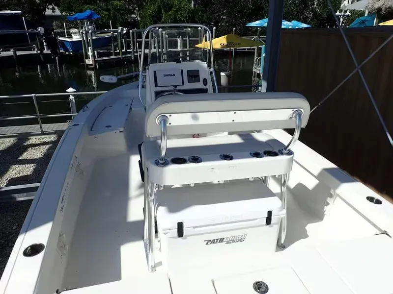 Slide: The Image of 2018 Pathfinder 2200 TRS boat at dock with helm console. - 3