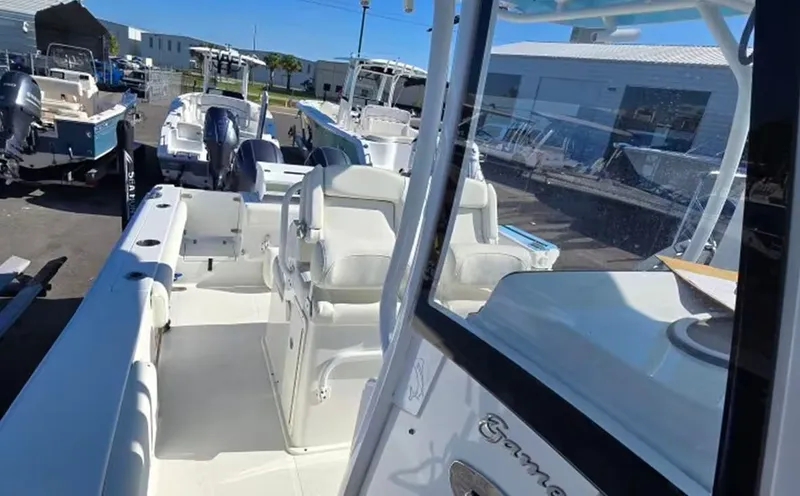 Slide: The Image of 2018 Sea Hunt Gamefish 27 boat parked at the marina. - 13