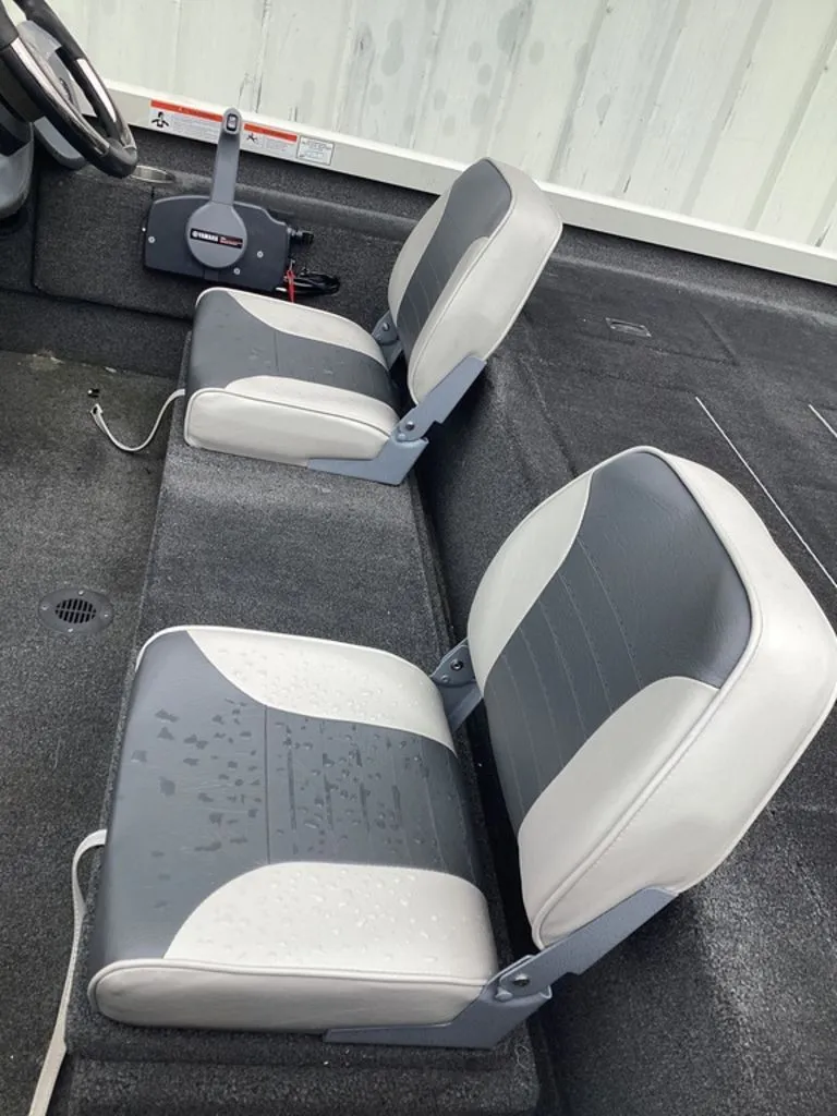 Slide: The Image of Interior of a 2013 Lowe Stinger 18 HP boat with gray seats. - 11