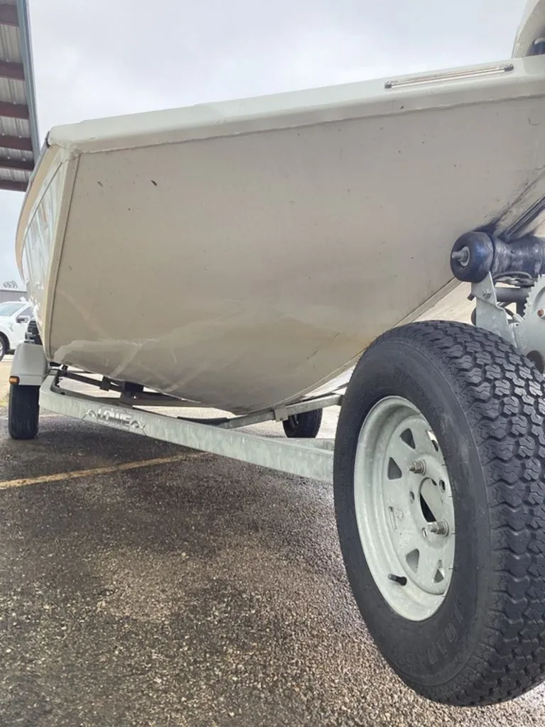 Slide: The Image of 2013 Lowe Stinger 18 HP boat on trailer, side view. - 18