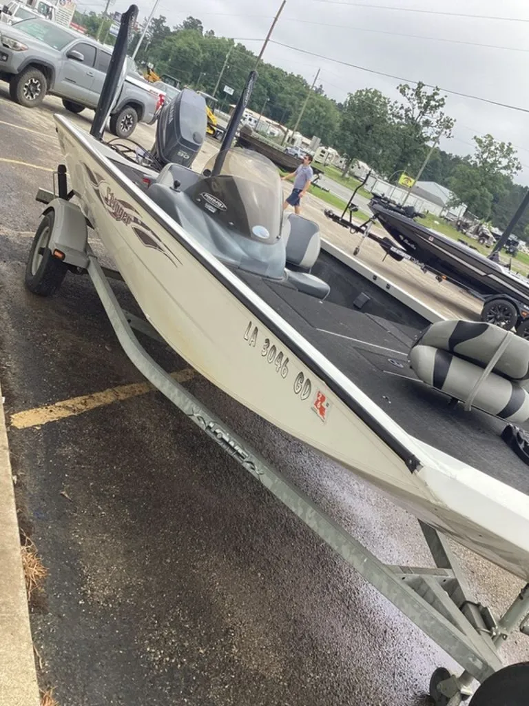 Slide: The Image of 2013 Lowe Stinger 18 HP boat parked on trailer outdoors. - 19