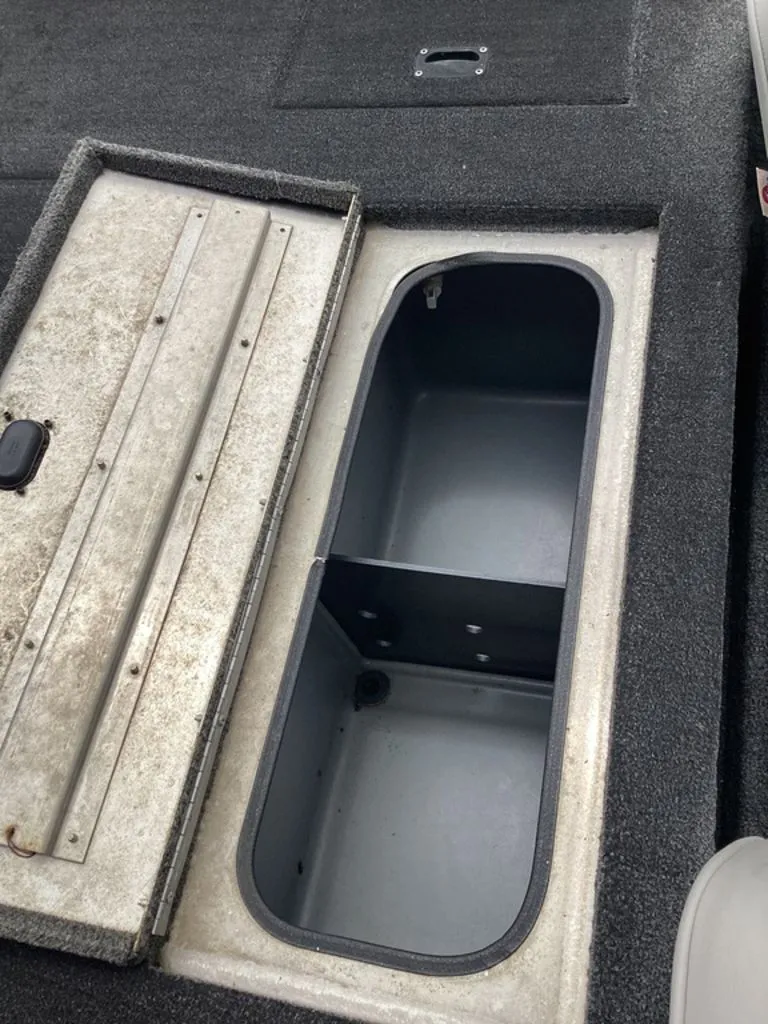 Slide: The Image of Open storage compartment of a 2013 Lowe Stinger 18 HP boat. - 27