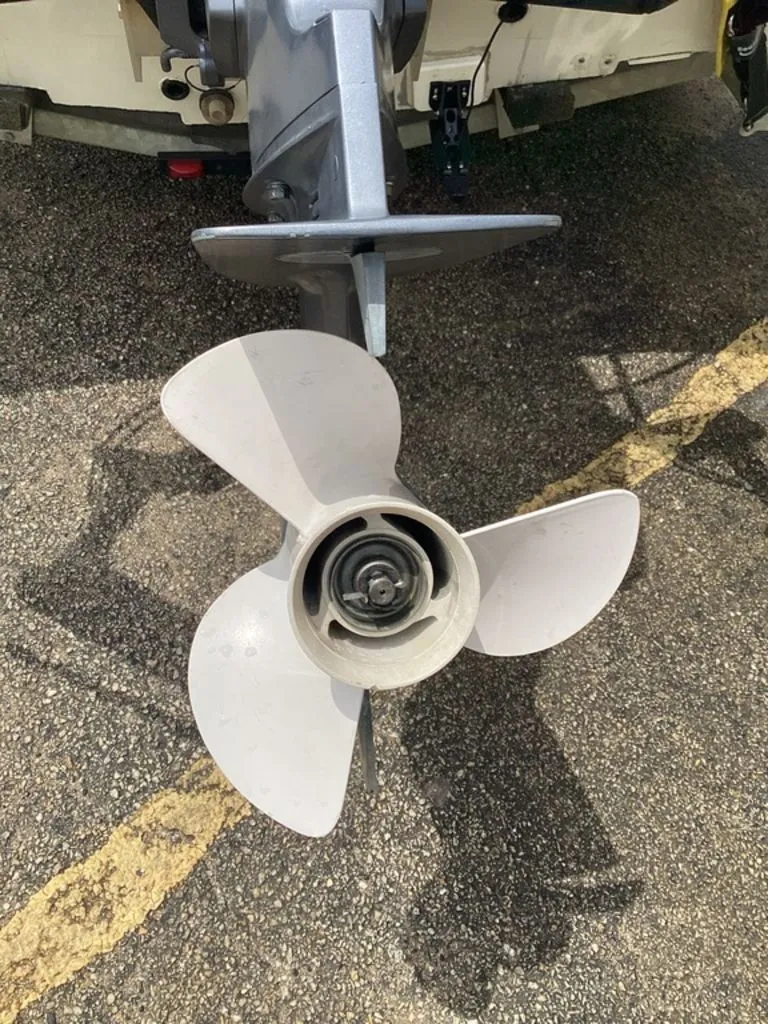 Slide: The Image of Propeller of a 2013 Lowe Stinger 18 HP boat on asphalt. - 31