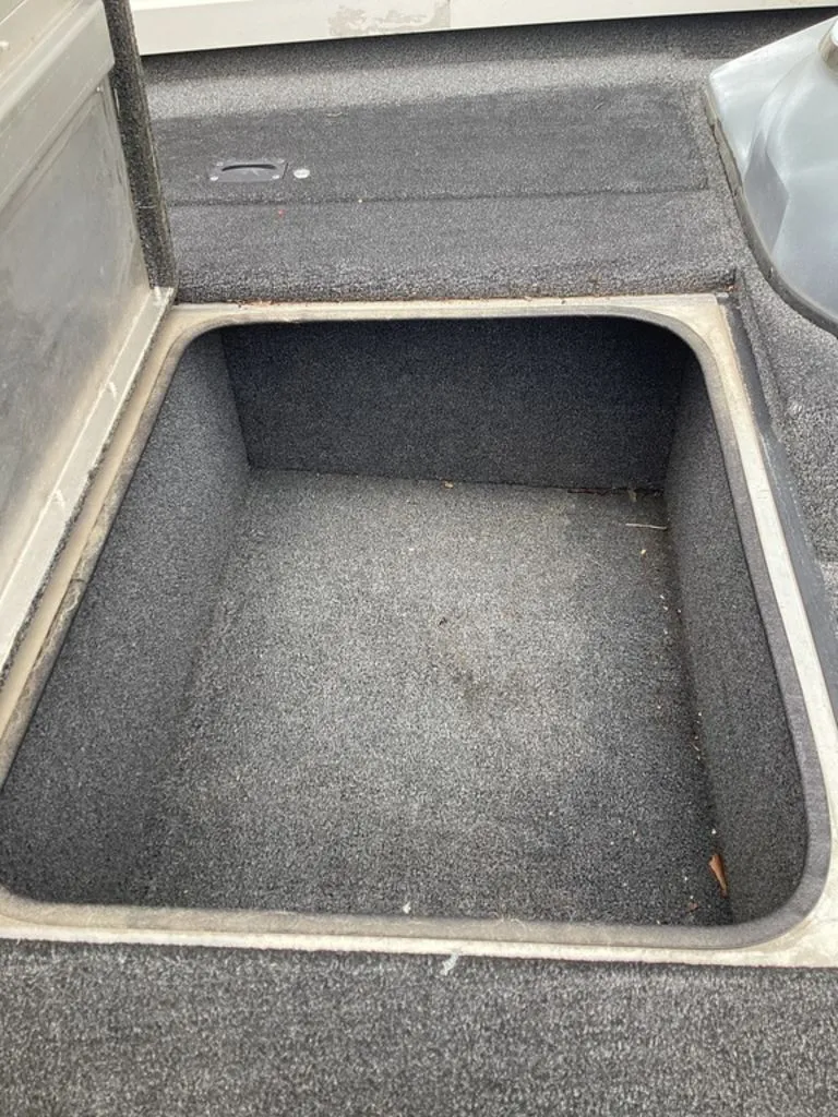 Slide: The Image of Open storage compartment in 2013 Lowe Stinger 18 HP boat. - 38