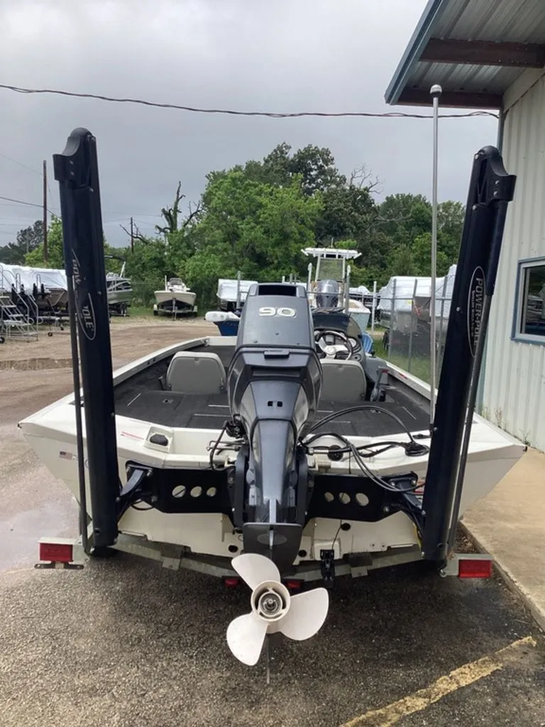 Slide: The Image of Rear view of a 2013 Lowe Stinger 18 HP boat with outboard motor. - 4