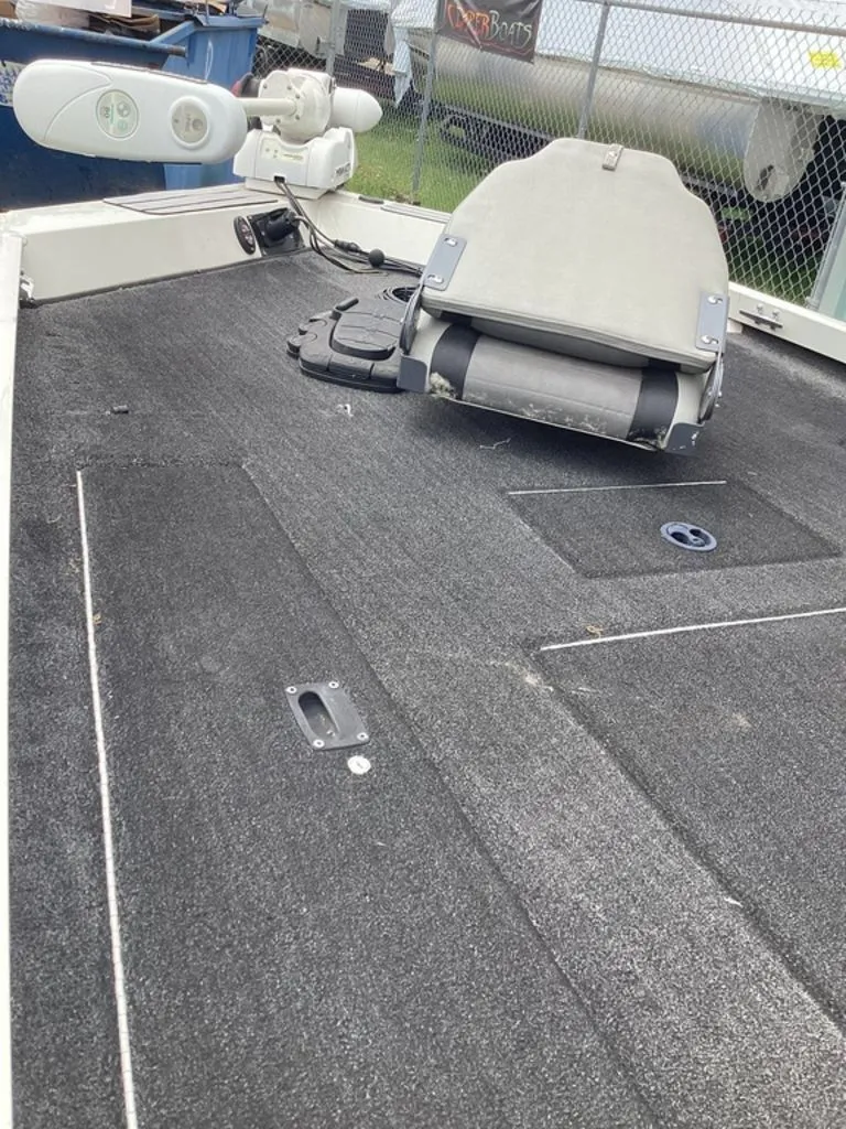 Slide: The Image of 2013 Lowe Stinger 18 HP boat with gray carpeted deck. - 42