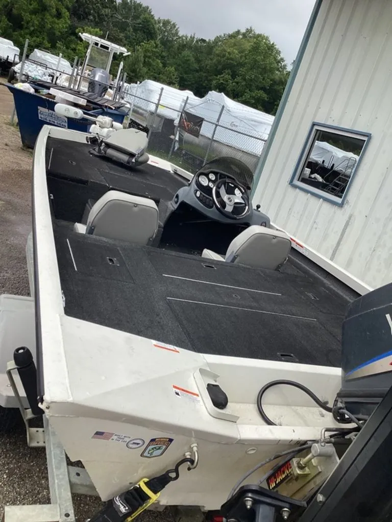 Slide: The Image of 2013 Lowe Stinger 18 HP boat parked on a trailer. - 5